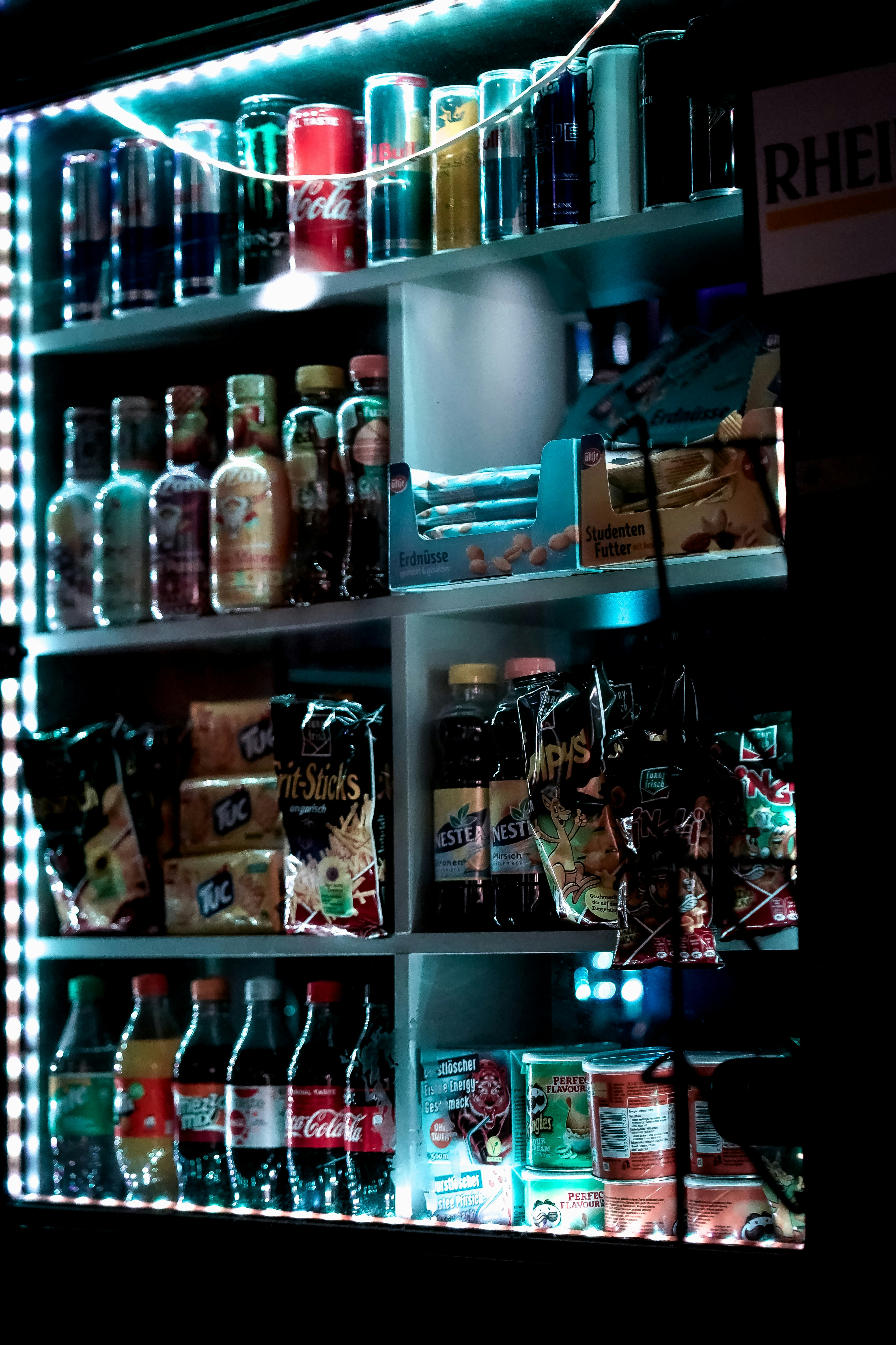 bottles on shelf with lights turned on during night time